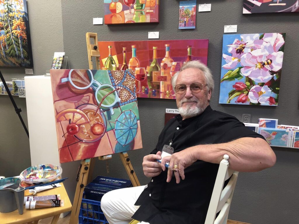 Artist busy with a painting at the Okanagan Art Gallery